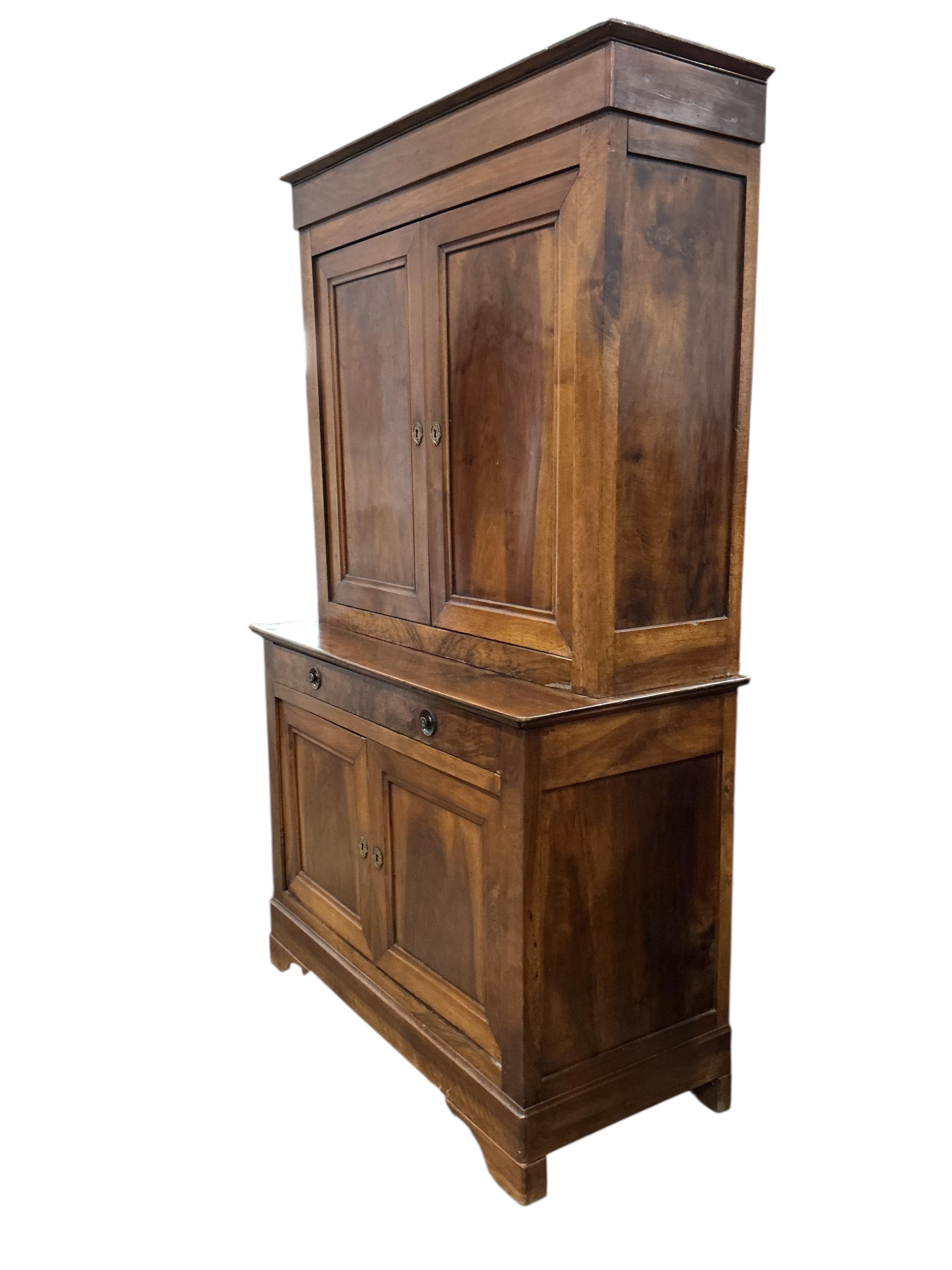 A 19th century French Biedermeier walnut side cabinet, width 125cm, depth 58cm, height 214cm
